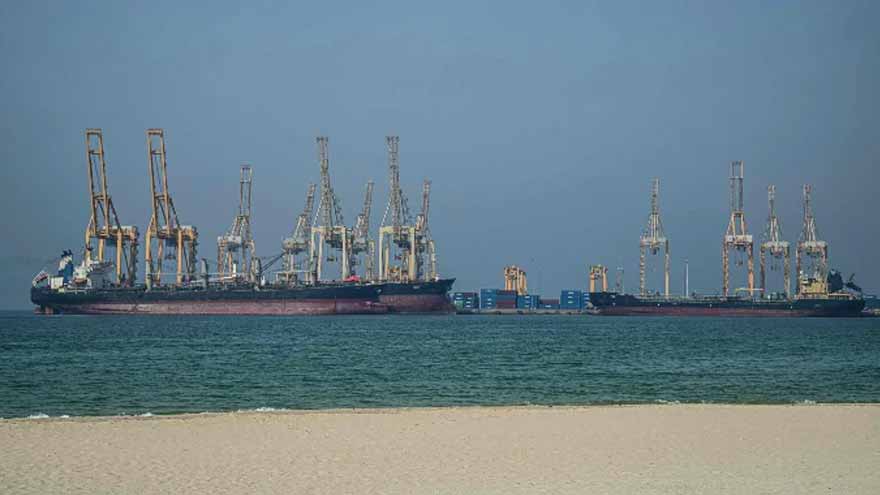 Crude edges up after wild swing, stocks track Wall St rally